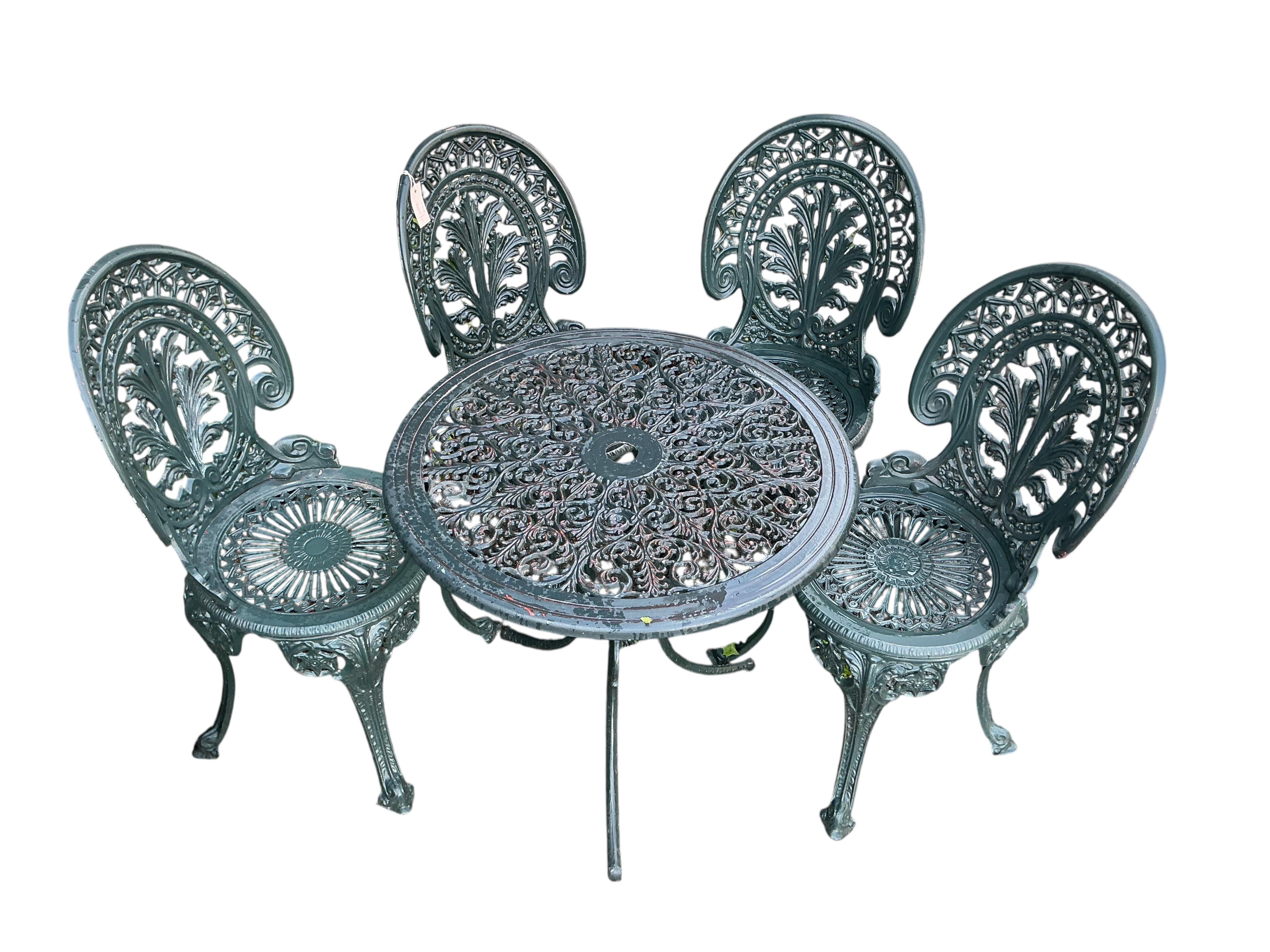 A Victorian style circular painted aluminium garden table, diameter 68cm, height 64cm together with four chairs